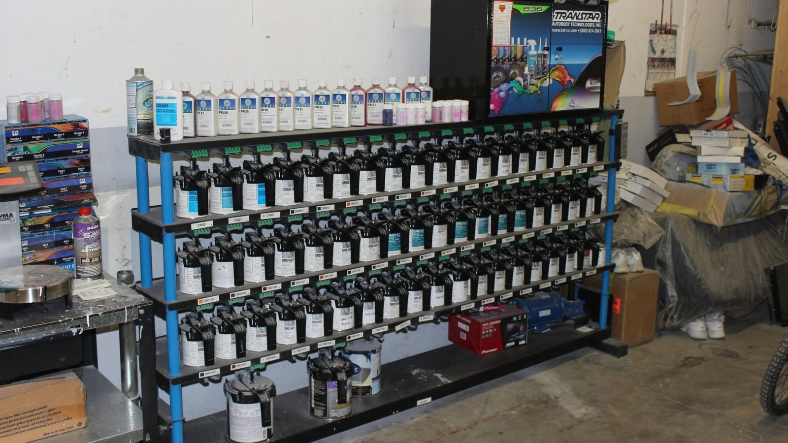 Paint mixing station with color draw-down cards, tinters, and a reference sample